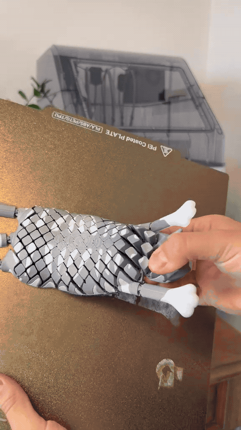 Hands bending the articulated cat fidget toy